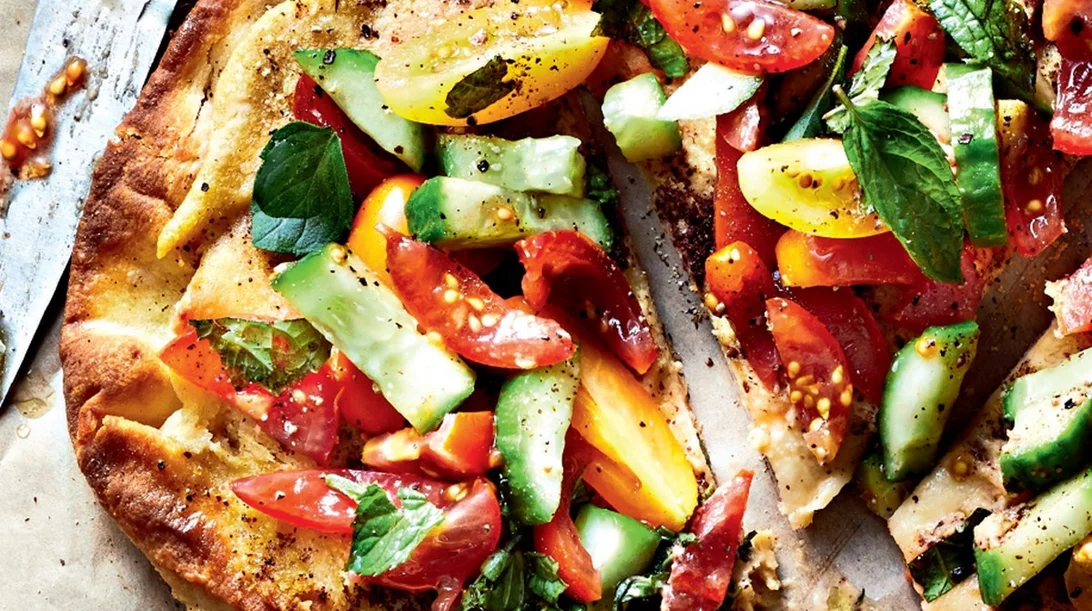 Ιδανικό και υγιεινό γεύμα: Πίτσα με χούμους, ντοματίνια, αγγούρι και σάλτσα δυόσμου