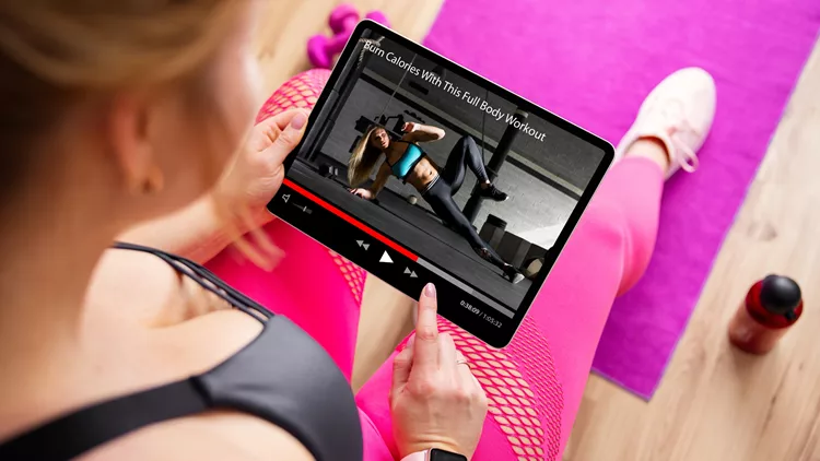 γυναίκα κοιτάζει youtube για ασκήσεις