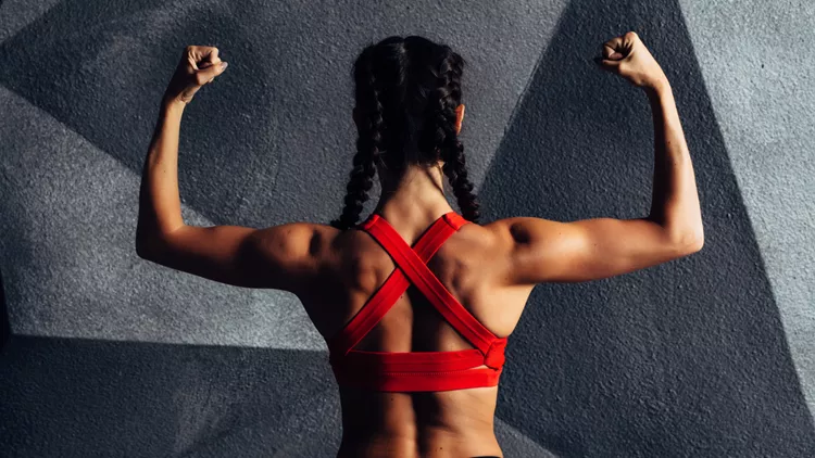 Back view portrait of a fitness woman showing biceps