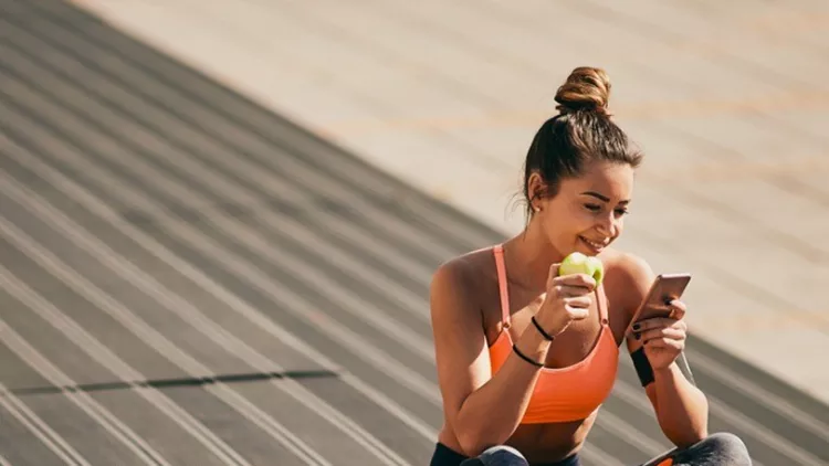 portrait-of-girl-sitting-on-stairs-after-exercising-picture-id935551910