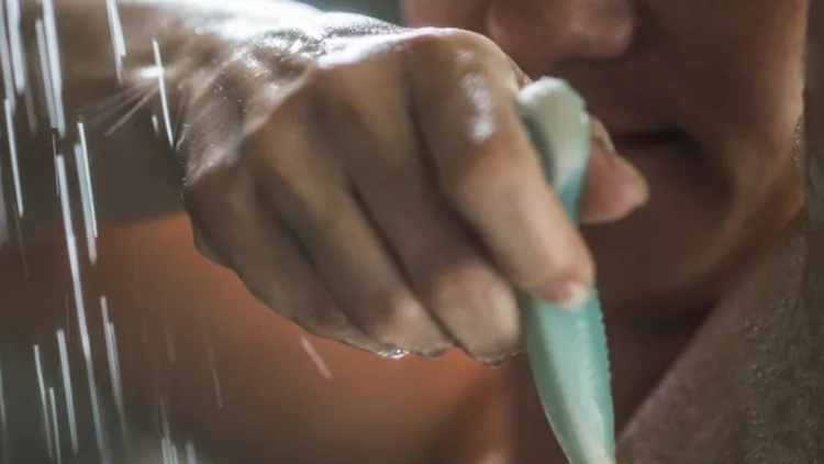 close-up-of-unrecognizable-woman-shaving-armpit-during-morning-shower-picture-id931606302