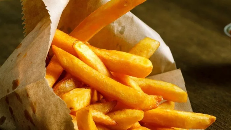 fresh-fried-french-fries-with-ketchup-on-wooden-background-picture-id497634198