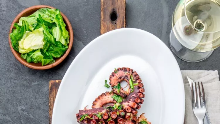 grilled-octopus-on-white-plate-serverd-with-white-wine-top-view-picture-id903870478 (1)