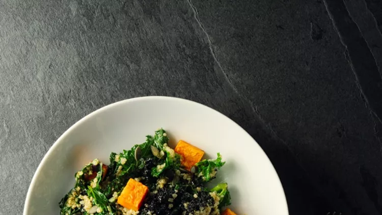 quinoa-and-kale-salad-with-roasted-sweet-potatoes-picture-id908289482