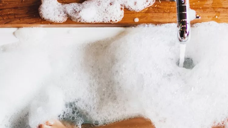 woman-legs-in-bath-foam-top-view-enjoying-and-relaxation-in-spa-hotel-picture-id997513944