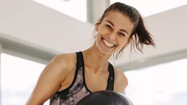 girls-working-out-in-fitness-studio-with-medicine-ball-picture-id943301778