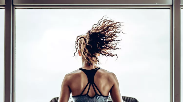 Beautiful attractive woman runs on the running track