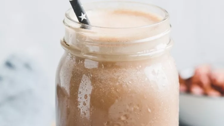 nut-butter-chocolate-protein-shake-in-a-glass-jar-the-concept-of-a-picture-id1059083212