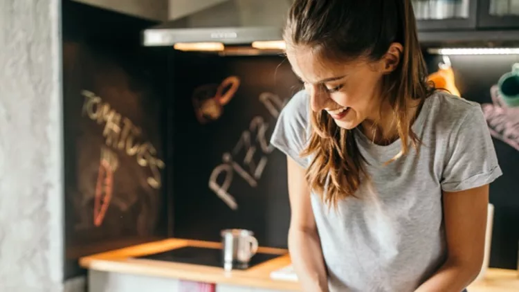 young-woman-preparing-pizza-picture-id1049042926