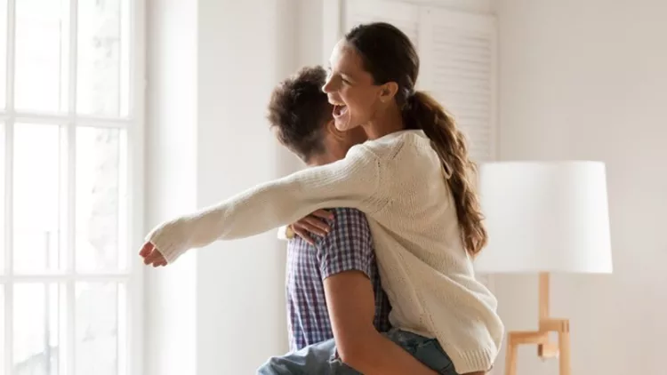 excited-couple-celebrating-moving-day-man-lifting-embracing-happy-picture-id938682824