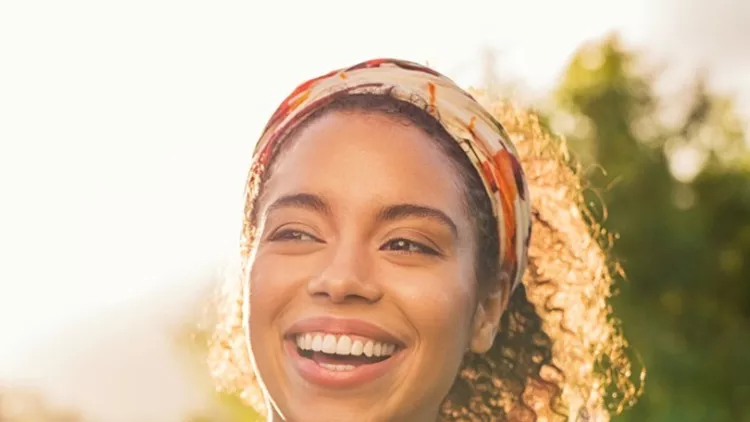 young-african-woman-smiling-at-sunset-picture-id969233490