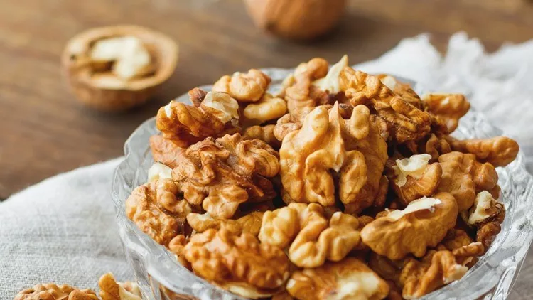 glass-bowl-with-walnuts-on-rustic-homespun-napkin-healthy-snack-picture-id531534806