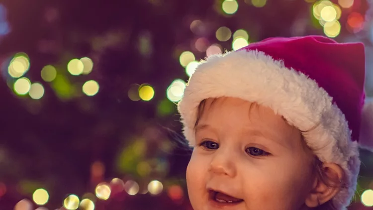 cute-boy-indoors-near-christmas-tree-picture-id1040563062