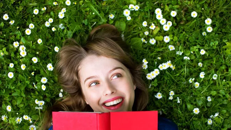 7231519 - woman lying on grass with book