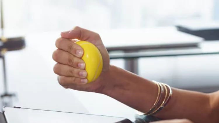 stressed-office-worker-with-anti-stress-ball-types-email-istockid508035582