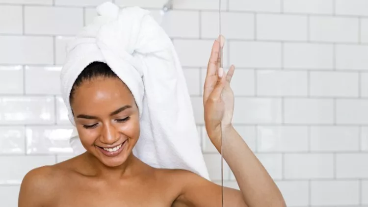 young-woman-in-white-towels-wrapped-around-head-and-body-after-shower-picture-id875430118