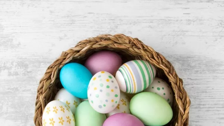 easter-eggs-on-white-wooden-table-background-picture-id657565390