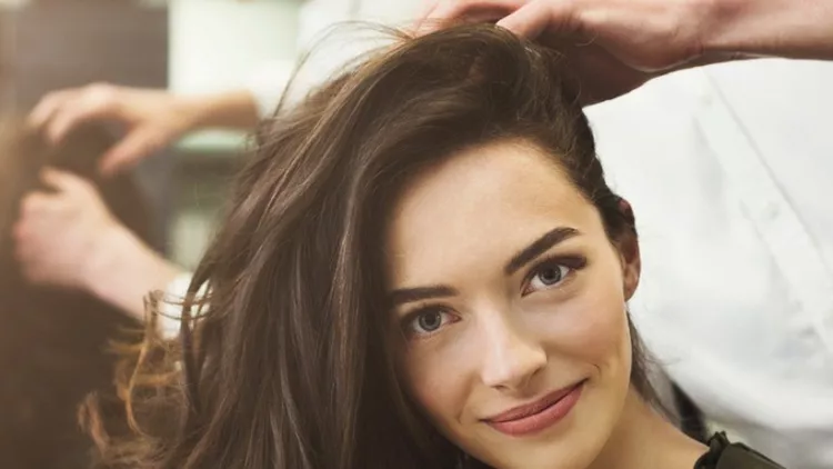 woman-sitting-at-beauty-salon-making-hairdo-picture-id1002144830