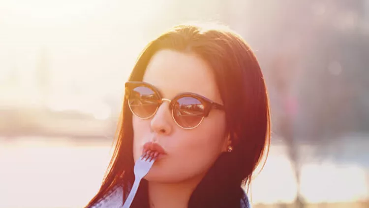 young-woman-with-fresh-salad-and-fork-outdoor-picture-id642308282