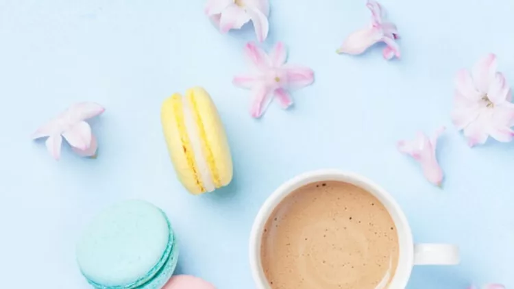 cake-macaron-or-macaroon-pink-flowers-and-coffee-on-blue-pastel-top-picture-id916033084 (1)