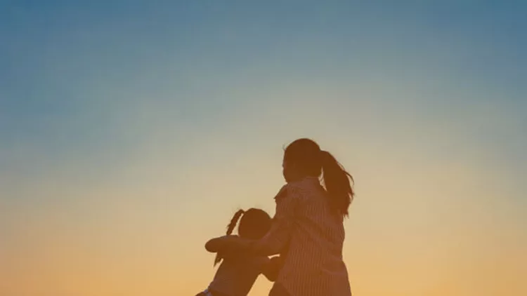 silhouette-of-a-happy-little-girl-child-running-into-the-arms-of-his-picture-id671127396