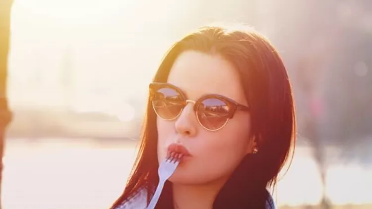 young-woman-with-fresh-salad-and-fork-outdoor-picture-id642308282