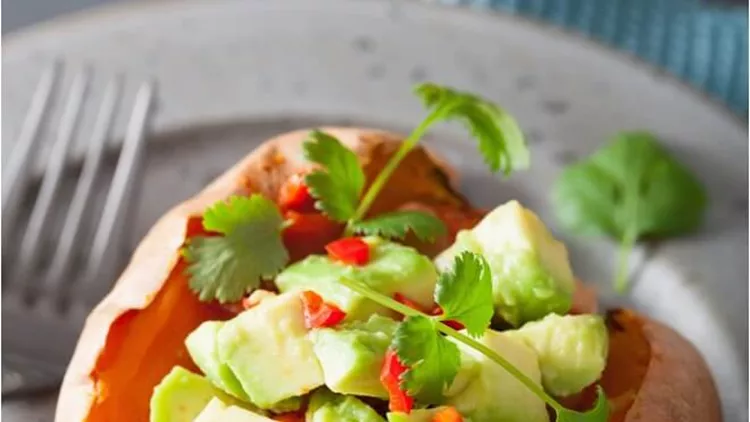 baked-sweet-potatoes-with-avocado-chili-salsa-and-beans-picture-id936469734 (1)