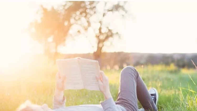 girl-reading-a-book-outside-header-picture-id686308788