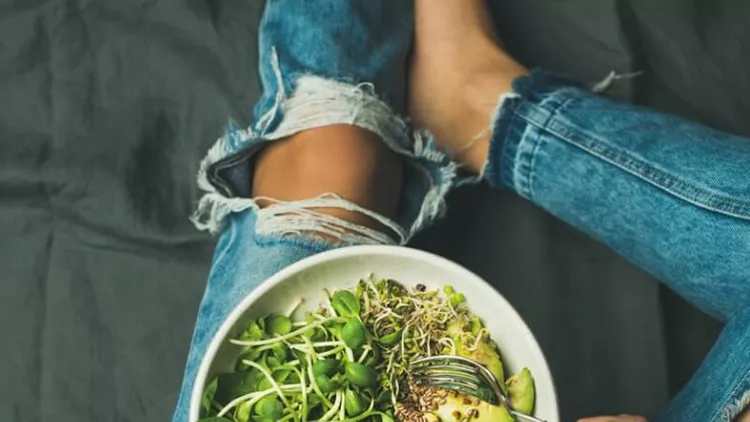 vegetarian-breakfast-bowl-with-spinach-arugula-avocado-seeds-and-picture-id692990626