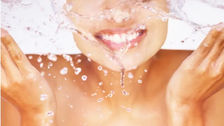 mid-section-a-cute-woman-splashing-water-on-her-face-picture-id157605592
