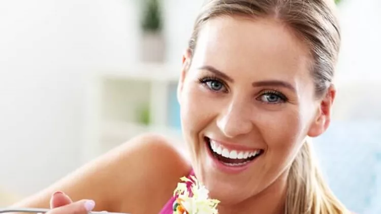 young-woman-eating-healthy-salad-after-workout-picture-id654715892