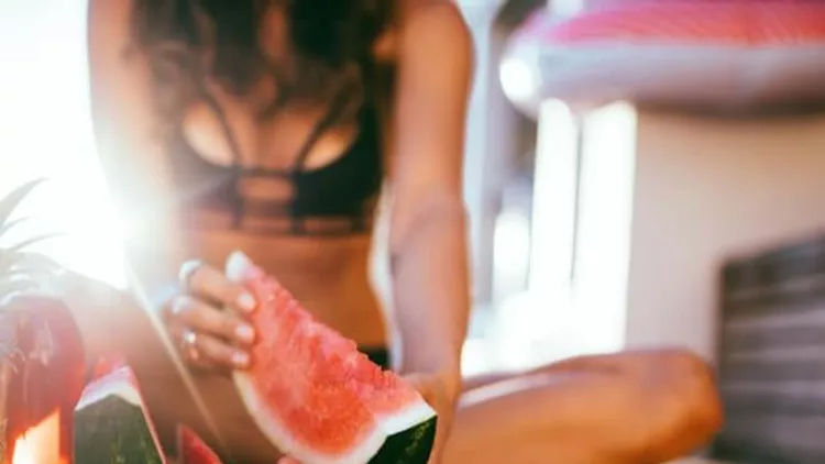 women-in-bikini-enjoying-fresh-fruit-platter-at-the-pool-picture-id639329996