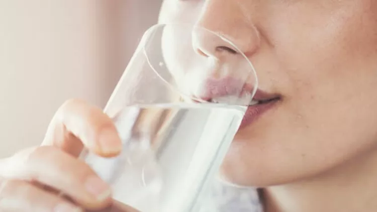 young-woman-drinking-pure-glass-of-water-picture-id935356228