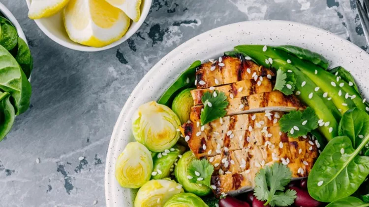 healthy-buddha-bowl-lunch-with-grilled-chicken-quinoa-spinach-avocado-picture-id920931456