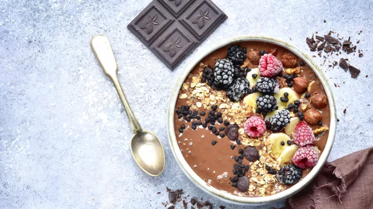 Chocolate banana smoothie bowl with frozen berries