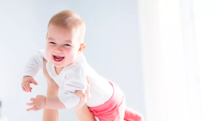 mother-and-baby-child-on-a-white-bed-picture-id854524104