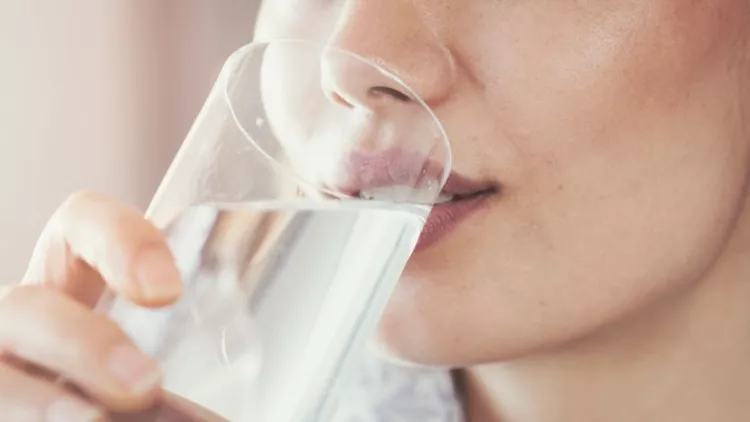 young-woman-drinking-pure-glass-of-water-picture-id935356228