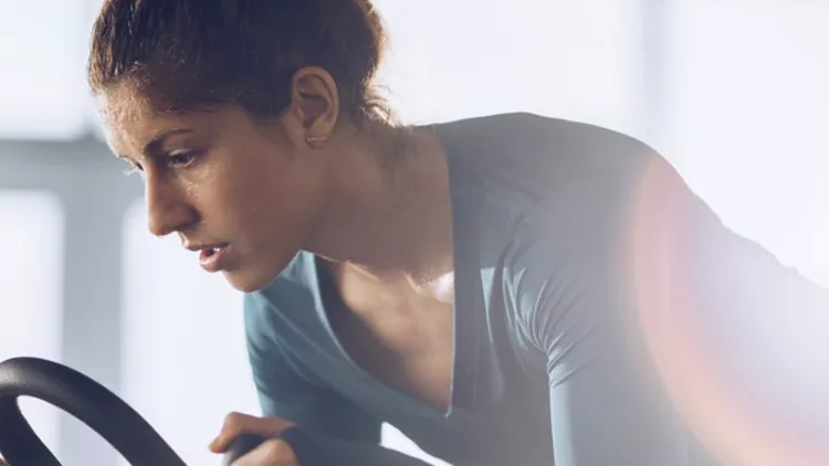 determined-female-athlete-on-a-spinning-class-in-a-health-club-picture-id907490830