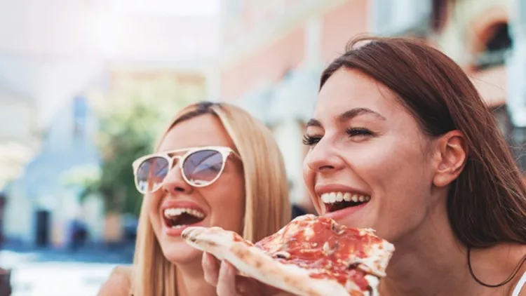 pizza-time-young-girls-eating-pizza-in-a-cafe-consumerism-lifestyle-picture-id878706062