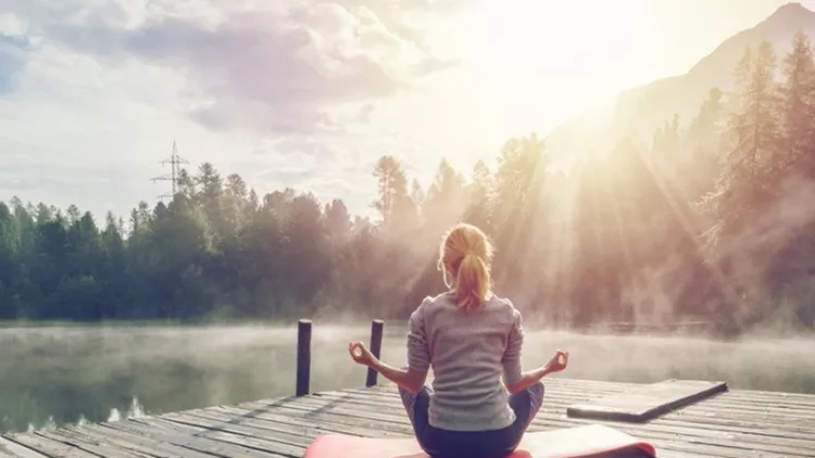 caucasian-girl-exercising-yoga-in-nature-morning-by-the-lake-in-picture-id868622860
