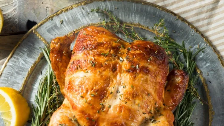 homemade-rotisserie-chicken-with-herbs-picture-id937574254