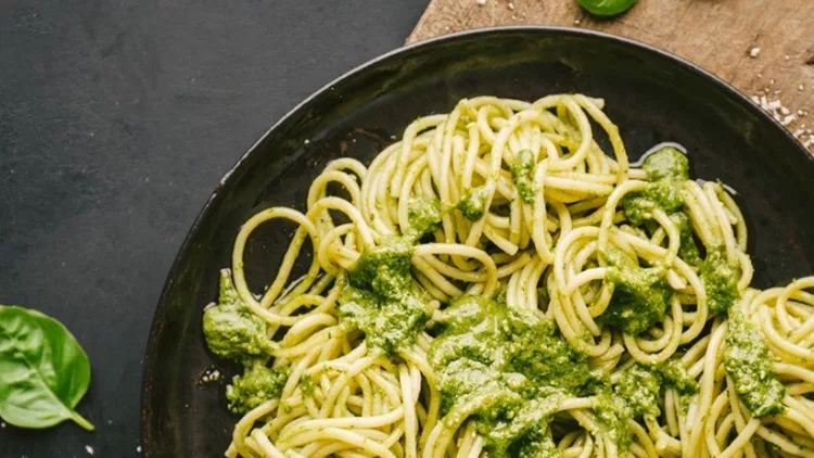 tasty-pasta-with-pesto-served-on-plate-picture-id1045283212