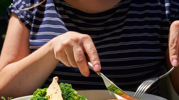 woman-eating-on-terrace-picture-id949446902