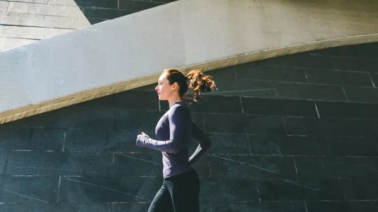 woman-jogging-or-running-side-view-with-shadow-picture-id916586372