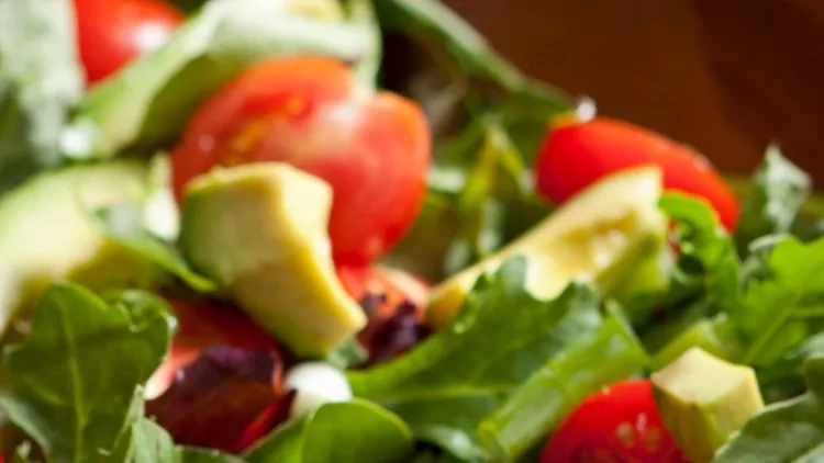 fresh-salad-with-cherry-tomatoes-avocado-and-mixed-greens-picture-id157680659
