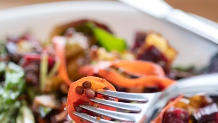 person-eating-vegan-beet-and-brussel-sprout-salad-picture-id1124986747