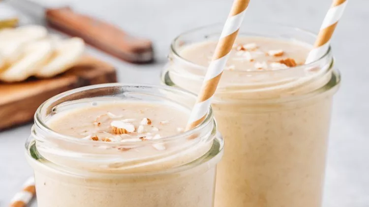 banana-almond-smoothie-with-cinnamon-and-oat-flakes-and-coconut-milk-picture-id1018364696