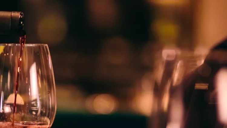 closeup-of-sommelier-serving-red-wine-at-fine-dining-restaurant-picture-id991732782