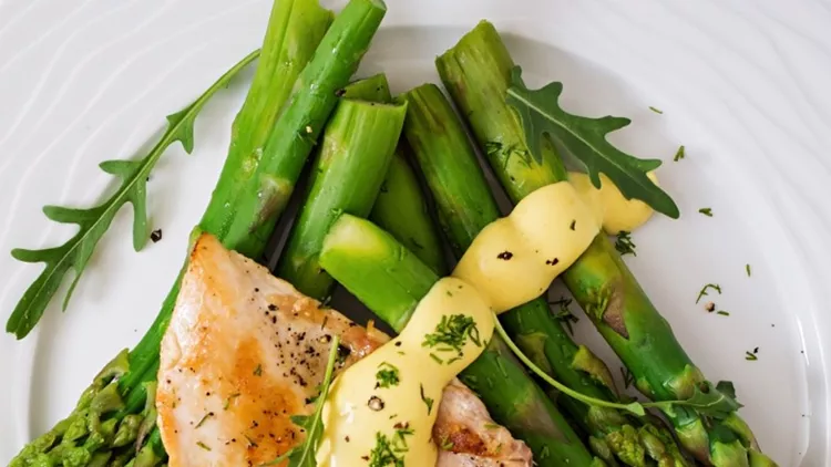 baked-chicken-garnished-with-asparagus-and-herbs-picture-id530415758
