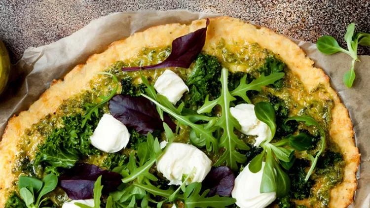 cauliflower-pizza-crust-with-pesto-kale-mozzarella-cheese-and-greens-picture-id959253190